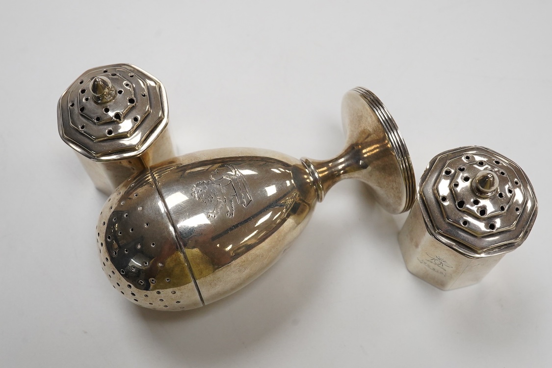 A George III provincial silver egg shaped pedestal pepperette, by Christian Ker Reid, Newcastle, circa, 1810, height 89mm, together with a pair of late Victorian octagonal pepperettes.